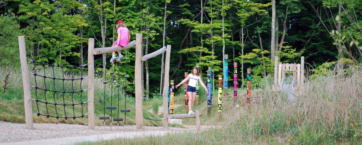 kids playing on natural outdoor equipment